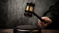 20271198 judge's hold hammer on wooden table