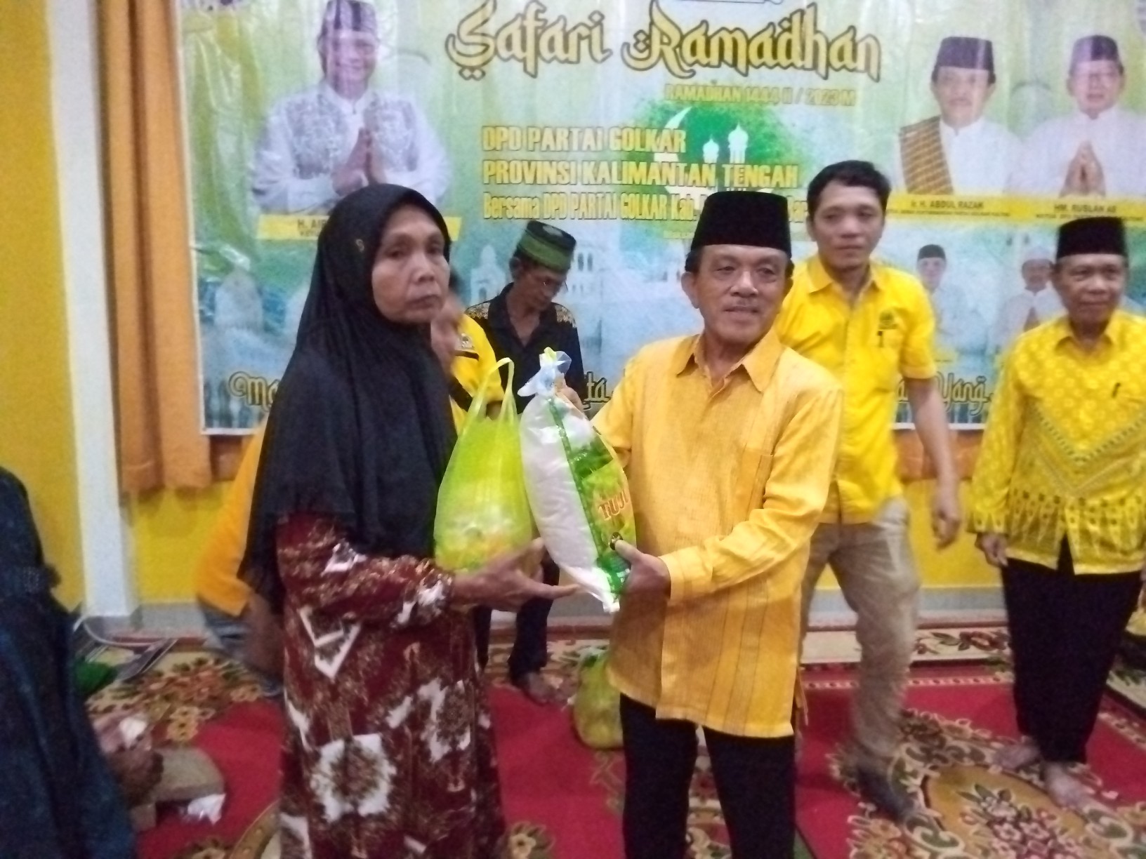 Penyerahan tali asih kepada masyarakat pada kegiatan buka puasa usai konsolidasi partai Golkar, Selasa (11/4).